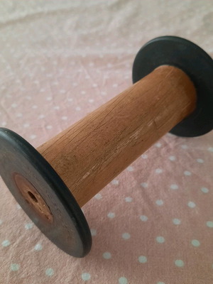 Wooden weaving spool used with black ends