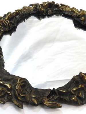 Solid brass wall mirror like new with carved floral motifs