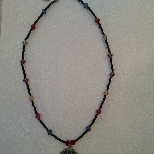 Necklace black with colorful stones and embossed face vintage like new
