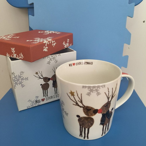 Christmas-themed mug with two reindeer