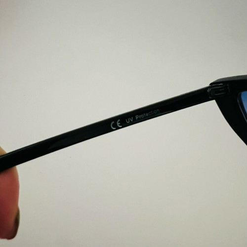 Glasses with blue triangular lens used, black frame
