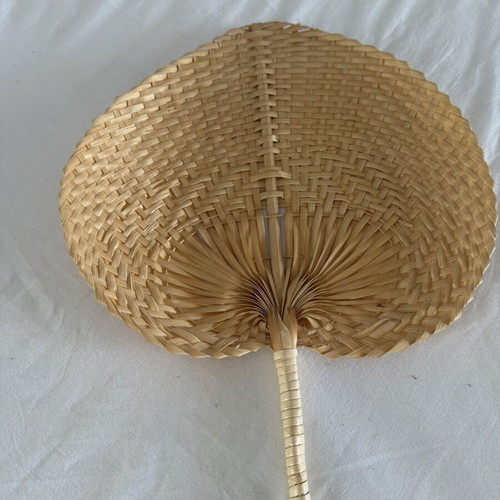 Handmade fans used, natural materials palm leaves and rattan