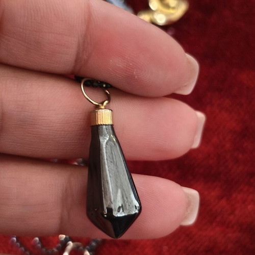 Long necklace used with black beads and hematite pendants