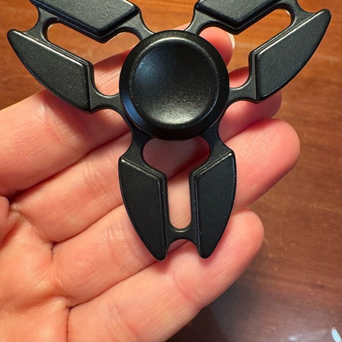Metal fidget spinner used, black ninja star shuriken design