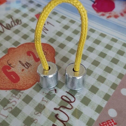 Metal worry beads used with yellow cord