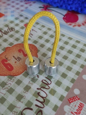 Metal worry beads used with yellow cord