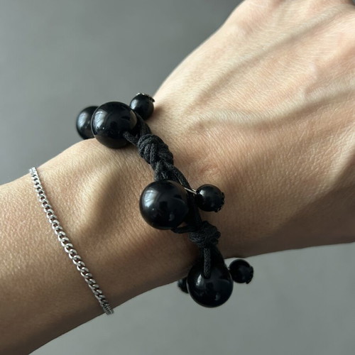 Black bracelet with beads and silver details like new, adjustable knot