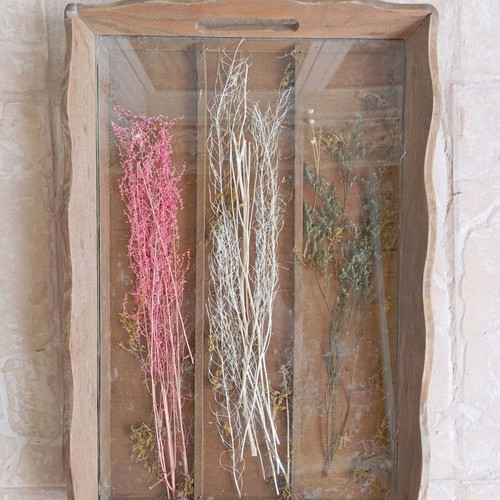 Wooden tray with glass and dried plants used