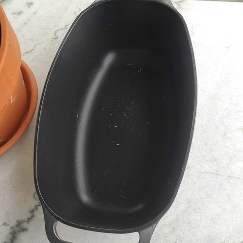 Glass Pyrex and cast iron pot used with surface wear