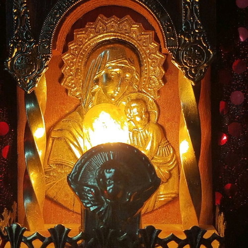 Vintage illuminated icon of Virgin Mary and Christ Child with lamp