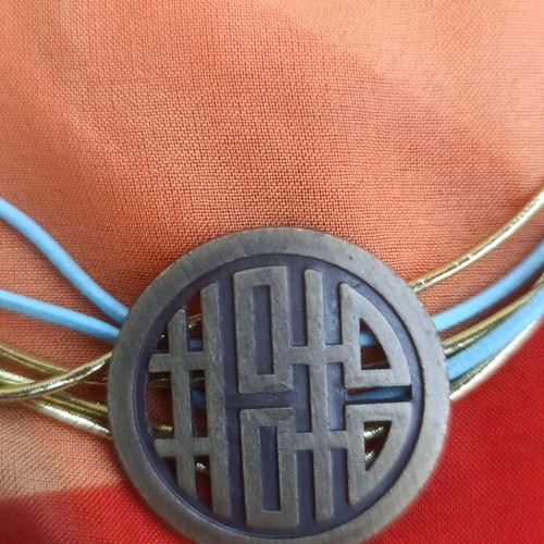 Metal necklace with turquoise and gold elastic cords