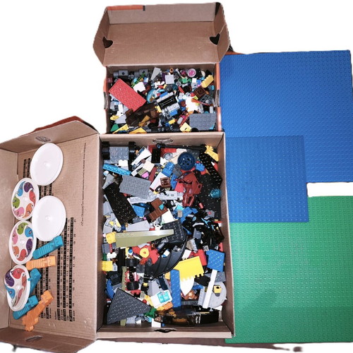 Lego boxes with pieces from various sets and 3 bases used