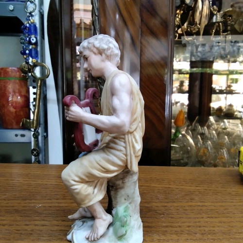 Ceramic figurine new with young male figure holding a lyre