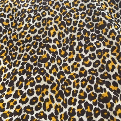 Animal print fabric for upholstery and throws, white with brown and orange
