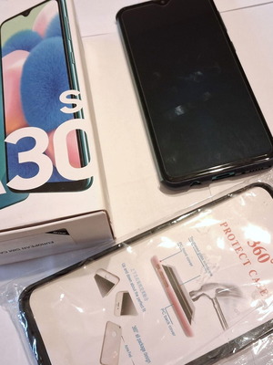 Samsung Galaxy A30s phone used with 2 cases included