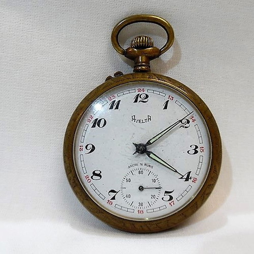 Old brass pocket watch with embossed design
