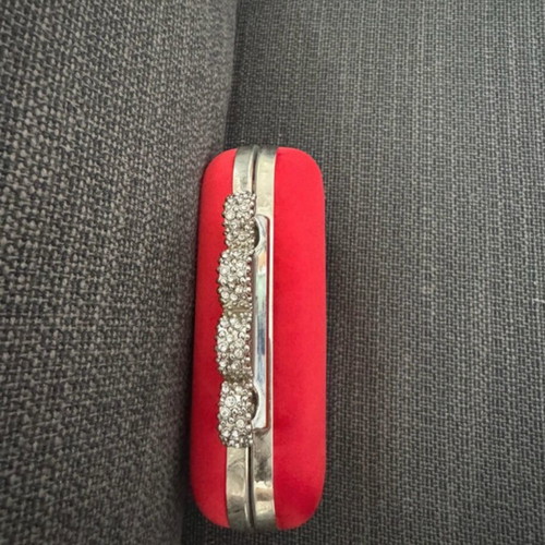 Red clutch like new with decorative clasp and chain