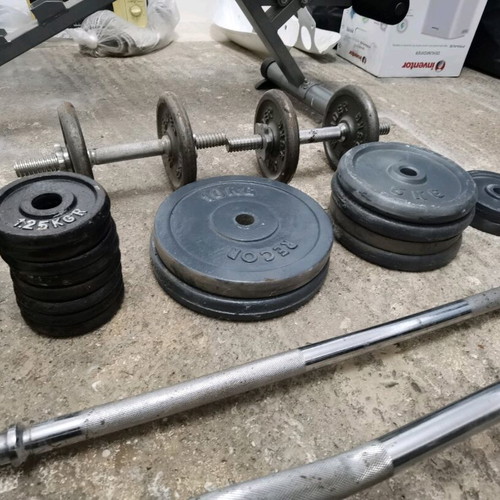 Gym equipment and weights used, set with Amila bench