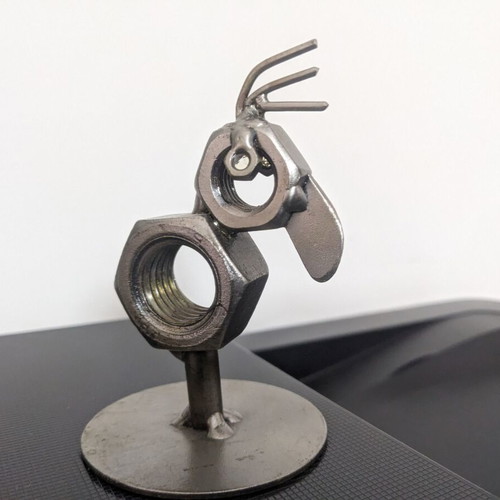 Decorative bird new made from metal nuts