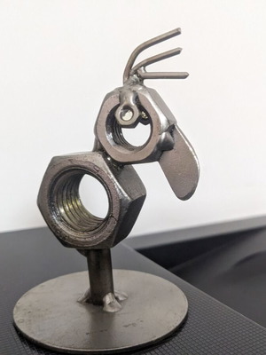 Decorative bird new made from metal nuts