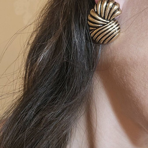 Metal earrings like new with ridges gold-colored