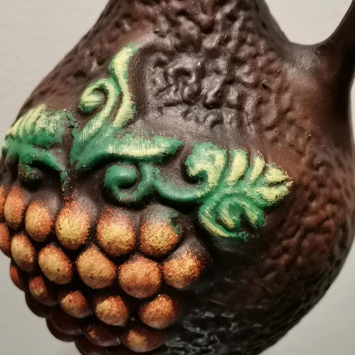 Clay jug used with embossed designs and grape cluster
