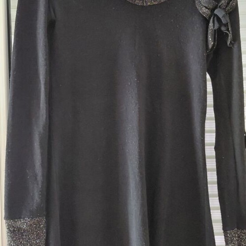 Women's black knitted winter dress with silver details and flower