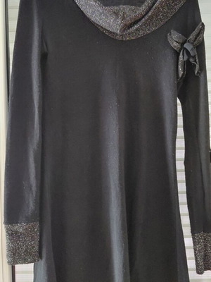 Women's black knitted winter dress with silver details and flower