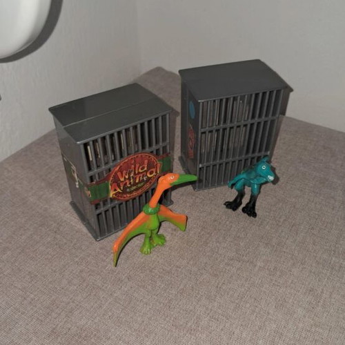 Dinosaur figures used, set in cages
