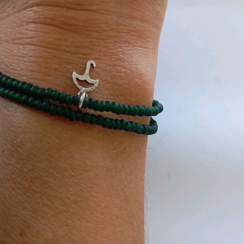 Handmade bracelet with green beads and silver umbrella charm