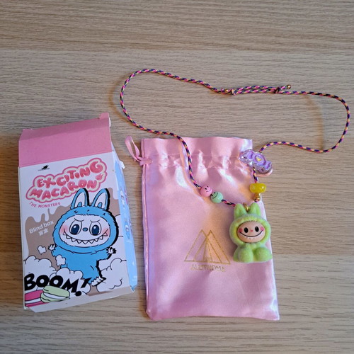 Labunoma necklace with colorful fuzzy smiling monster charm, like new