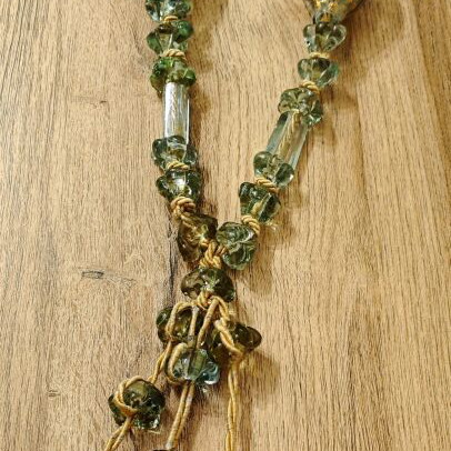 Tabletop komboloi with green and gold glass beads