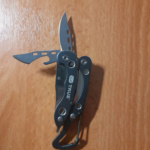 Survival multitool like new with knife, saw, screwdriver and pliers