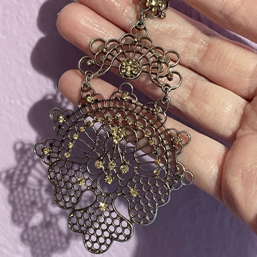 Long gold-plated earrings used with bronze-tone rhinestones