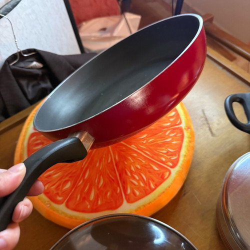 Non-stick frying pan used, red, lightweight and practical
