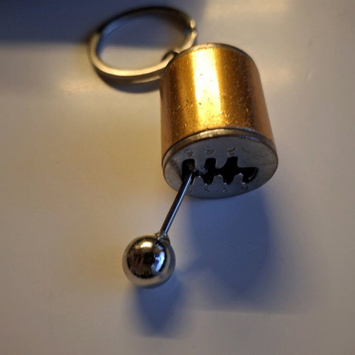 Gear shift lever keychain like new, orange and silver