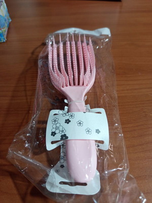 Pink detangling hair comb