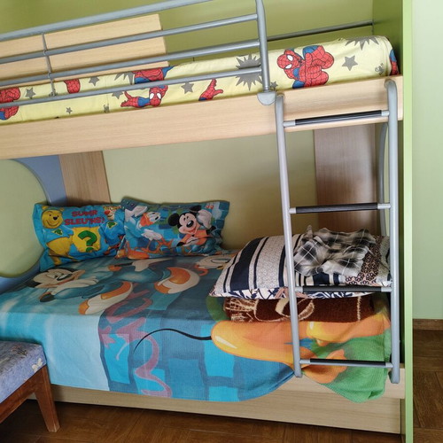 Bunk bed with three mattresses used, includes desk and drawers