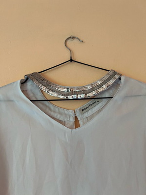 White blouse with silver details around neckline size M like new