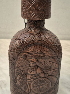 Vintage glass bottle with embossed leather Cervantes & Don Quixote