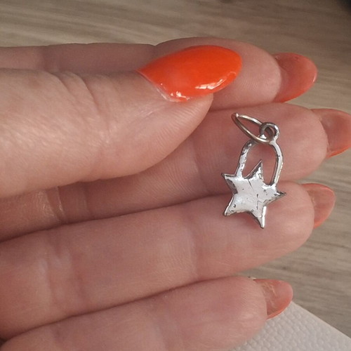 Charm star decorated with sparkling stones used, silver