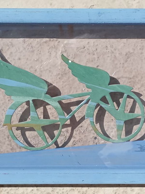 Artwork by Kostas Spyropoulos with flying bicycle theme, blue wooden frame