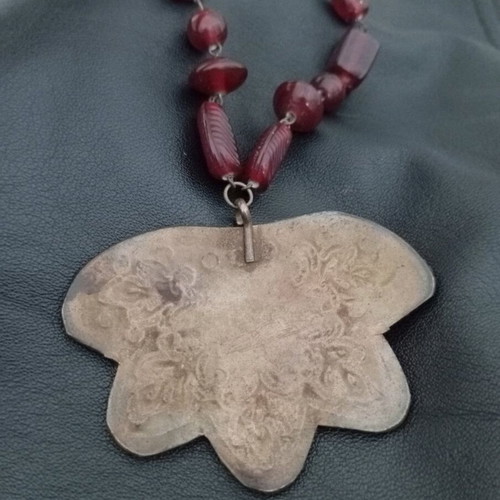 Necklace like new with red beads and metal leaf pendant