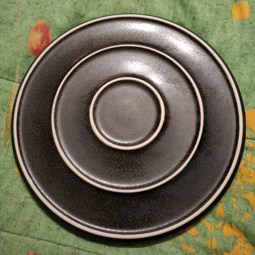 Porcelain plate used, black with small chip