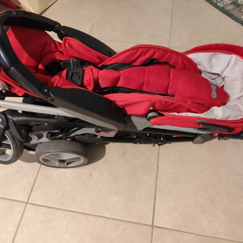 Kiddo Smart Deluxe stroller used with footmuff and changing bag, red