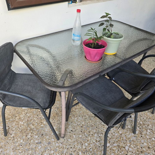 Outdoor dining set used with glass table and 4 chairs