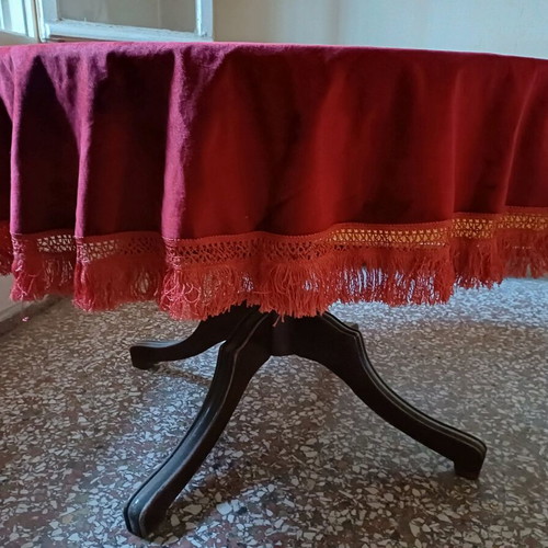 Round table with red tablecloth used, vintage wood design