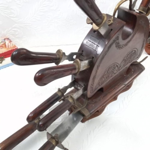 Wooden carved stand with used set of knives and forks