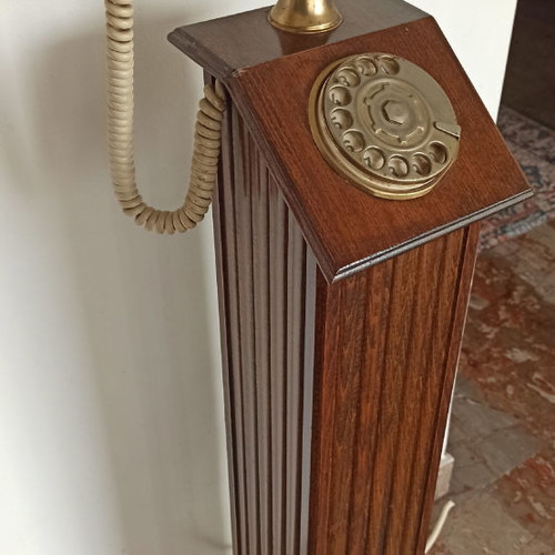 Antique hotel telephone used, wooden column with brass supports