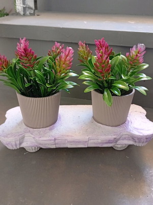 Composition new with handmade plaster base and two pots with artificial plants